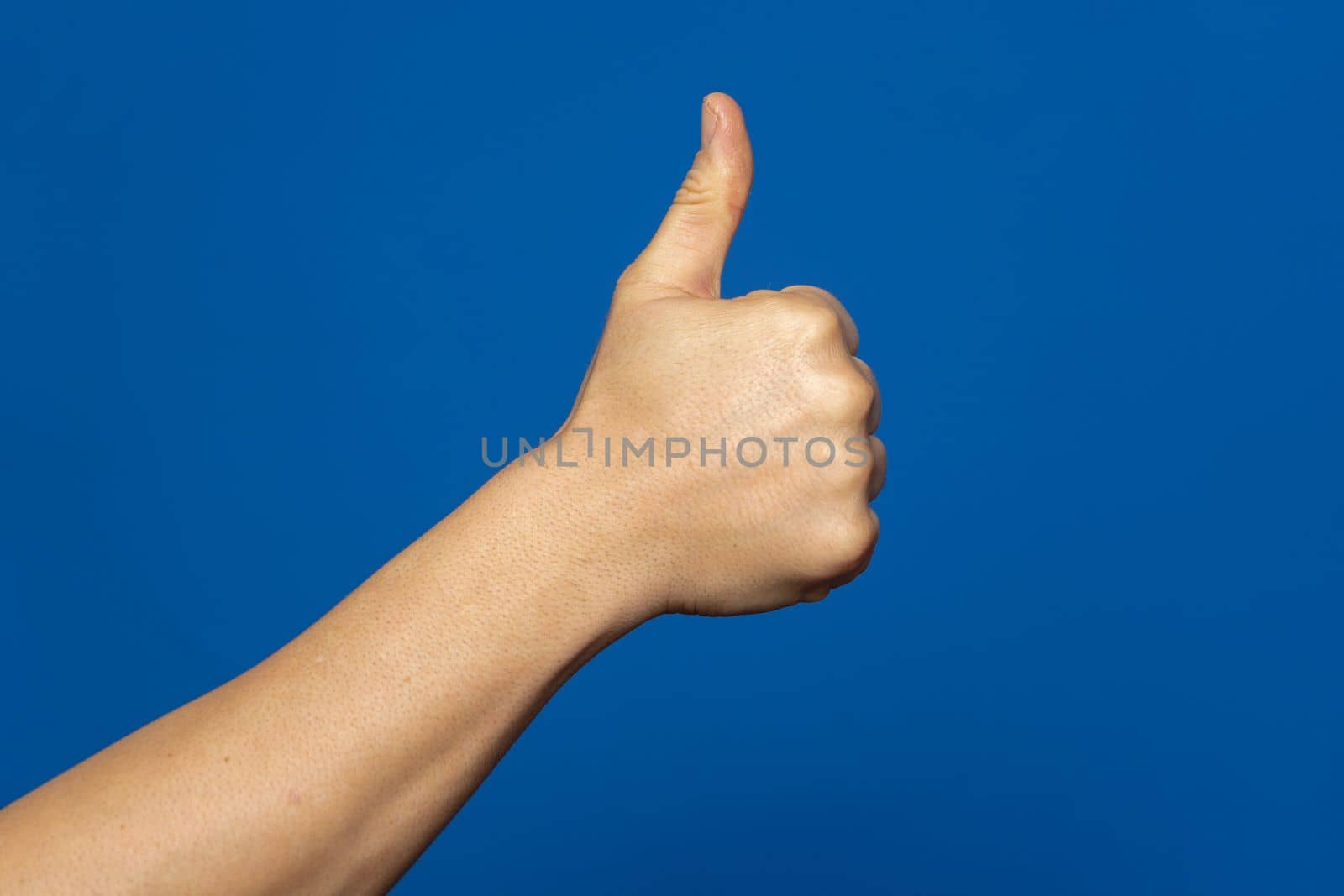 Thumbs up isolated on blue background, with clipping path, concept Admiration, Excellent