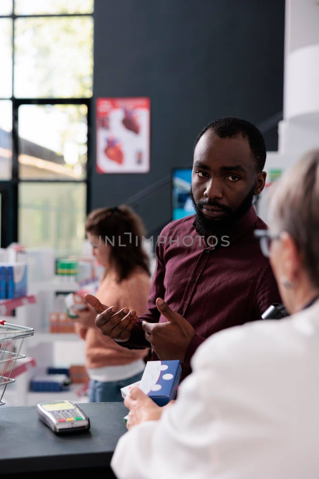 African american client asking pharmacist for help with medicaments prescription discussing health care treatment by DCStudio