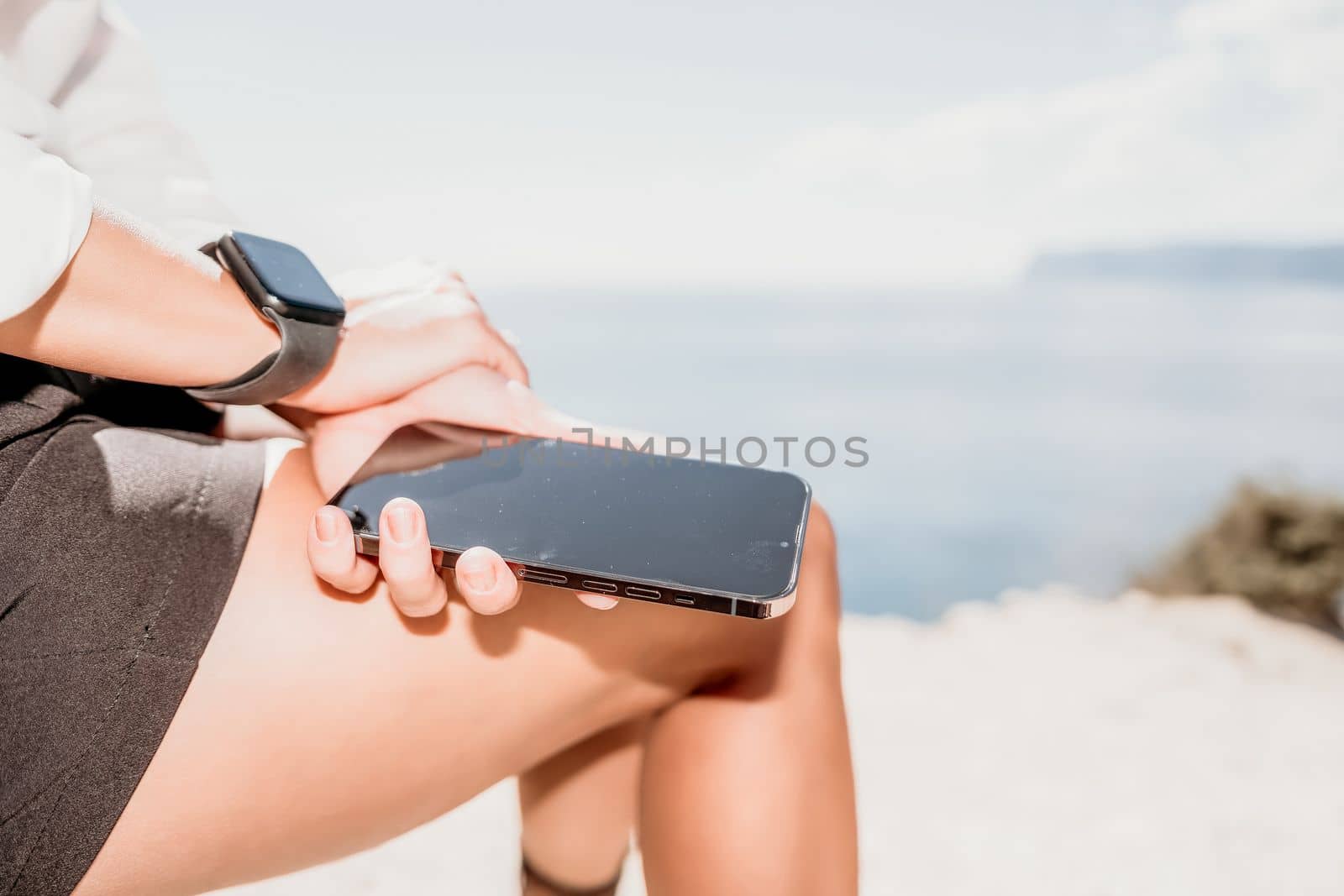 Happy girl doing yoga with laptop working at the beach. beautiful and calm business woman sitting with a laptop in a summer cafe in the lotus position meditating and relaxing. freelance girl remote work beach paradise