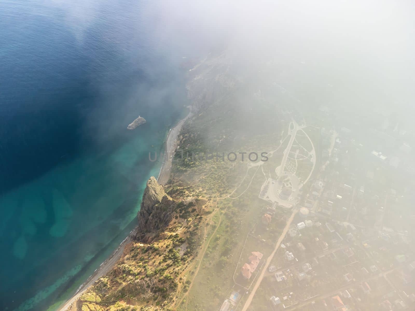 Aerial view. The drone flies over foggy and fluffy clouds. Blue sky sun and sea fog. Abstract aerial nature summer ocean sunset sea and sky background. Horizon. Vacation, travel and holiday concept by panophotograph