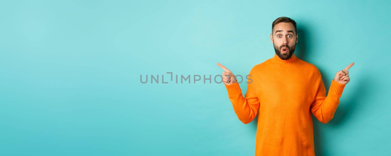 Shopping and advertisement concept. Excited man buyer pointing fingers sideways, showing two choices products, left and right banners, standing over light blue background by Benzoix