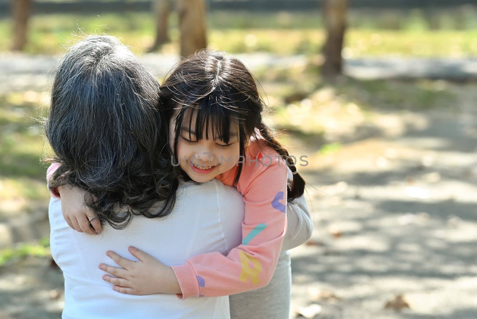 Adorable little asian girl hugging grandma, happy moment, best friend gratitude for love concept by prathanchorruangsak