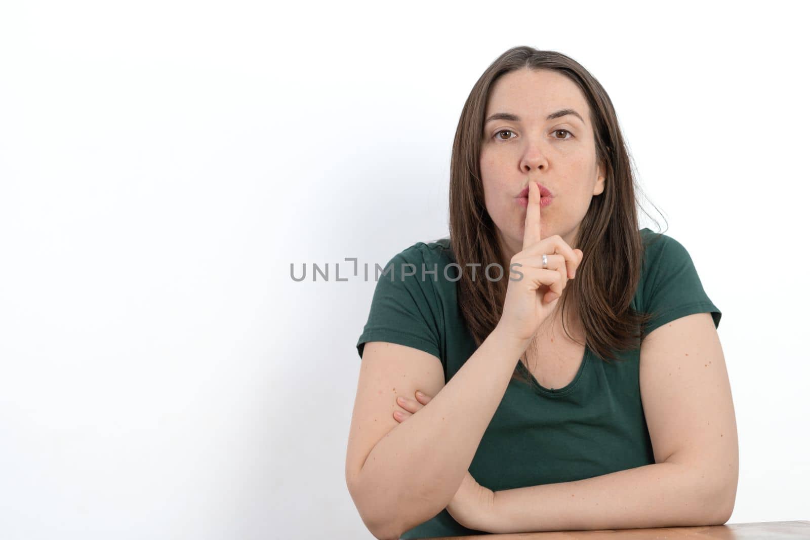 woman with her finger in her mouth asking for silence by joseantona