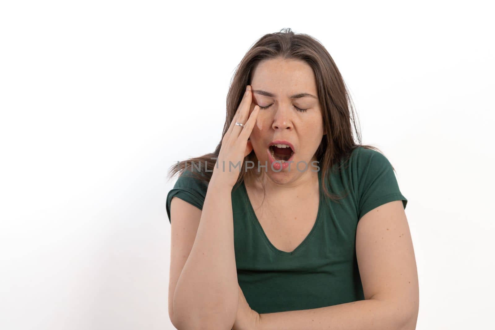 long-haired brunette woman yawning white background by joseantona