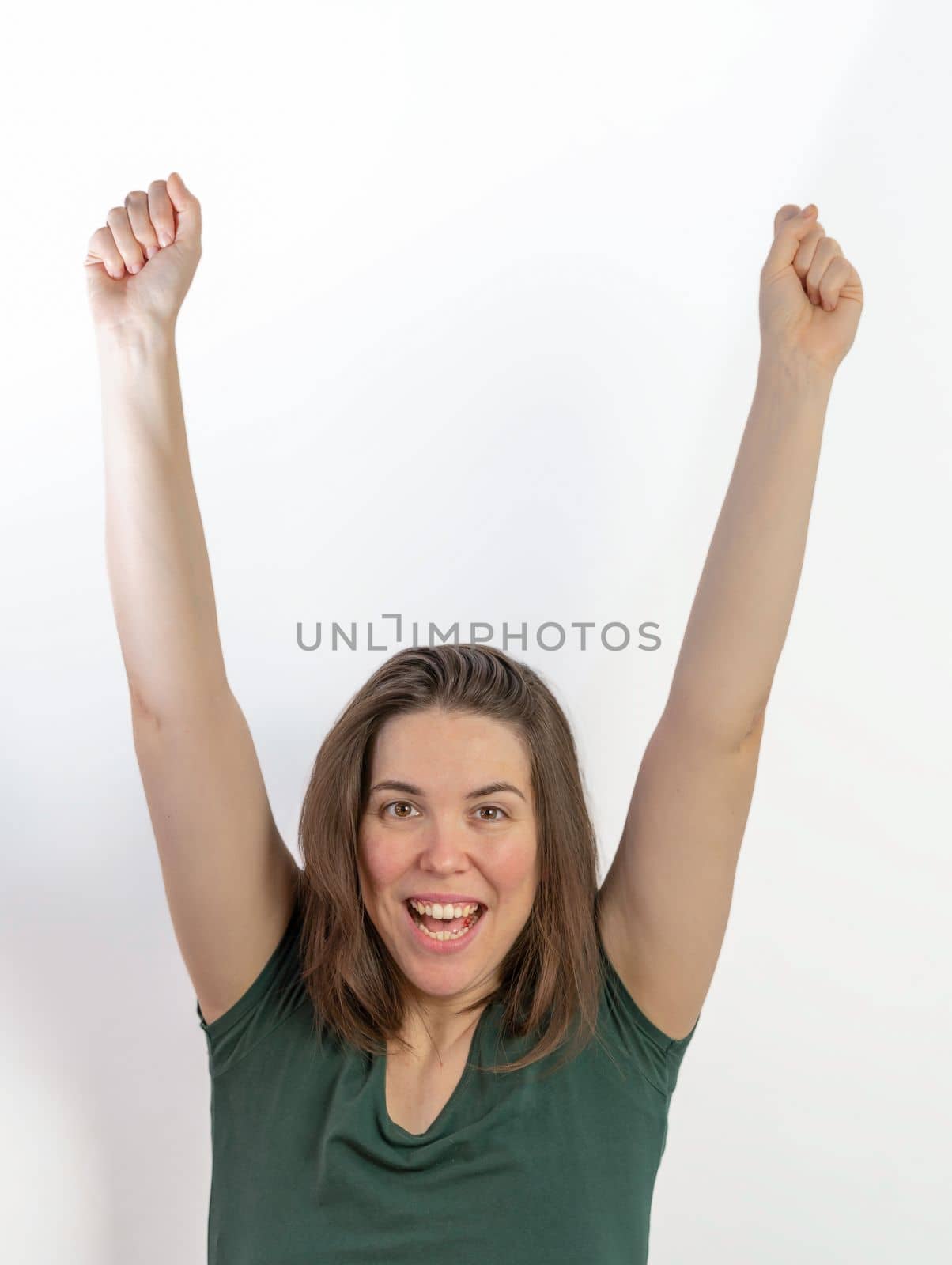 close-up of woman with raised arms symbolizing victory smiling with white background