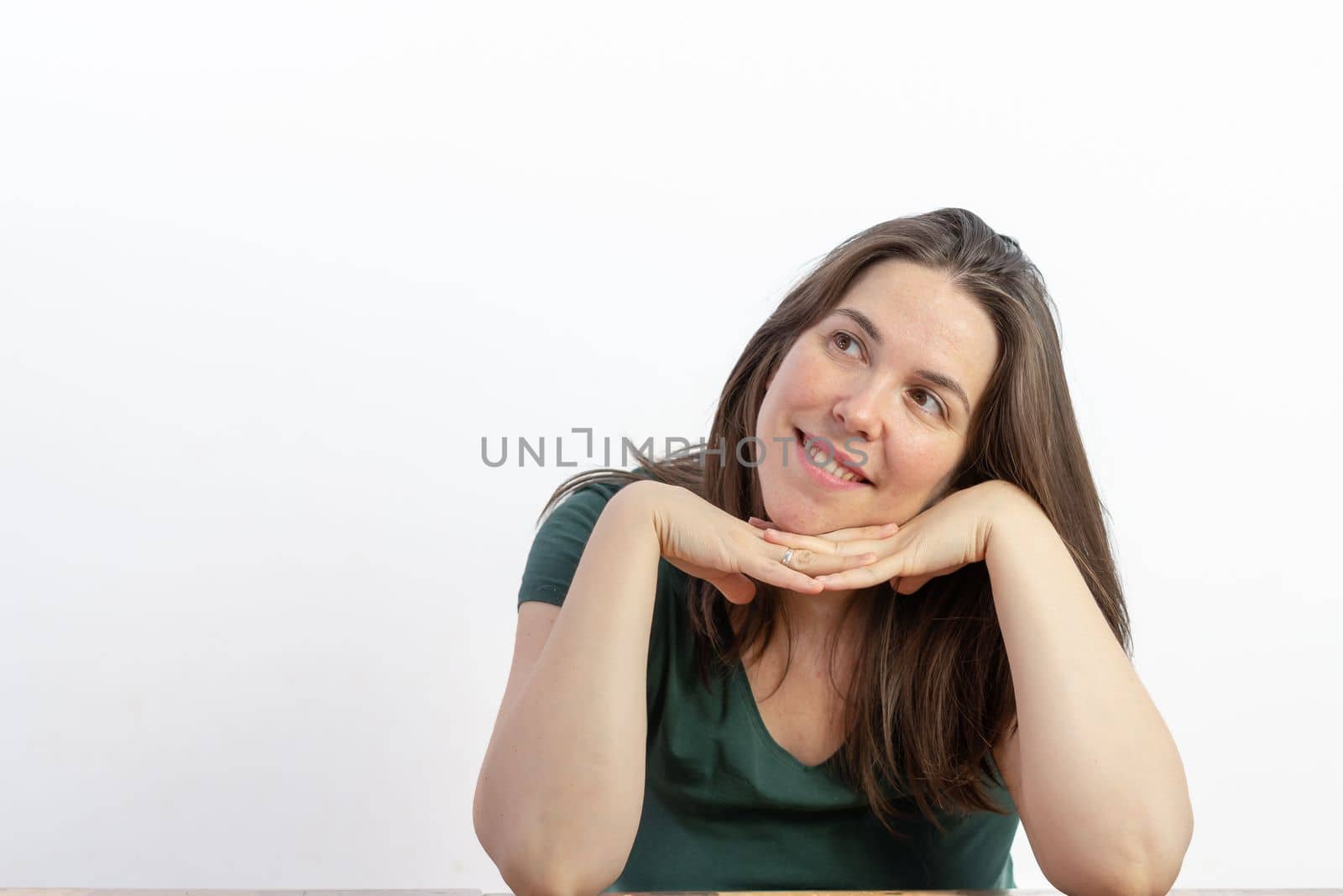 woman smiling with her face in her hands looking up at the dreamy sky, with a white background