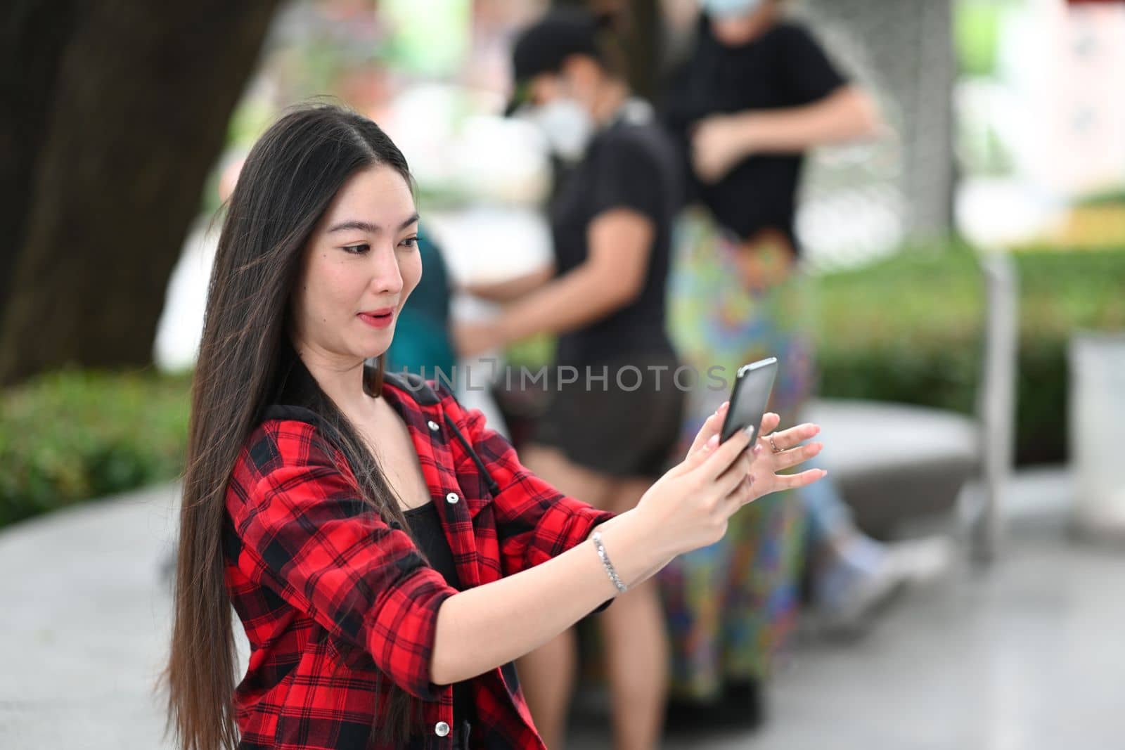 Young Asian woman using smart phone and holding credit card for shopping online. by prathanchorruangsak