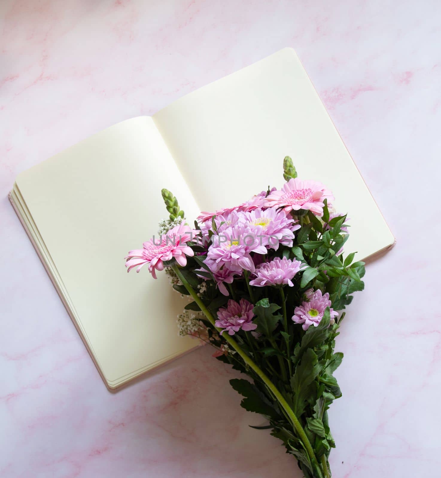 bouquet with pink gerberas and chrysanthemums and blank notebook for sketching and notes, pink. High quality photo