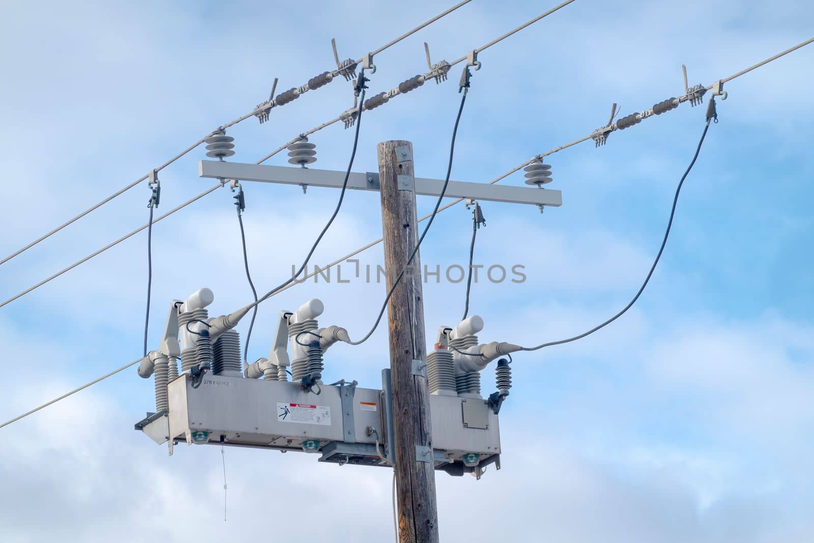 Back view of an electric three-phase overhead distribution switch. Concept: Power outages by oasisamuel