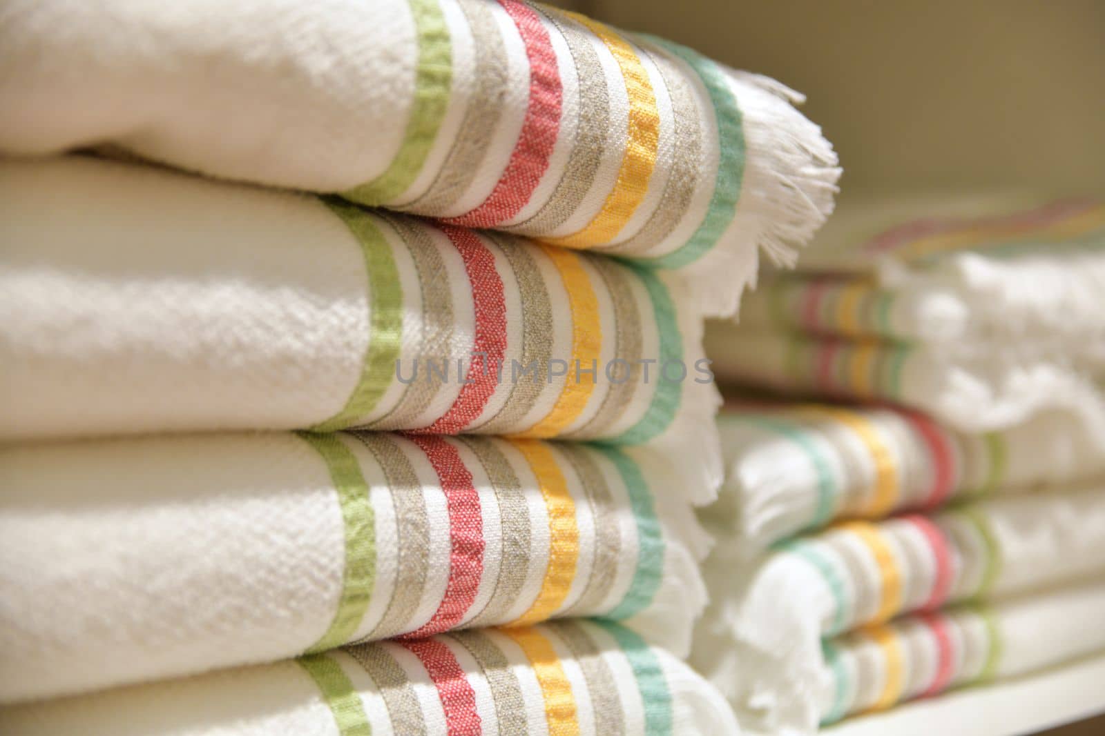 Folded bedspreads on a shelf in a shop store