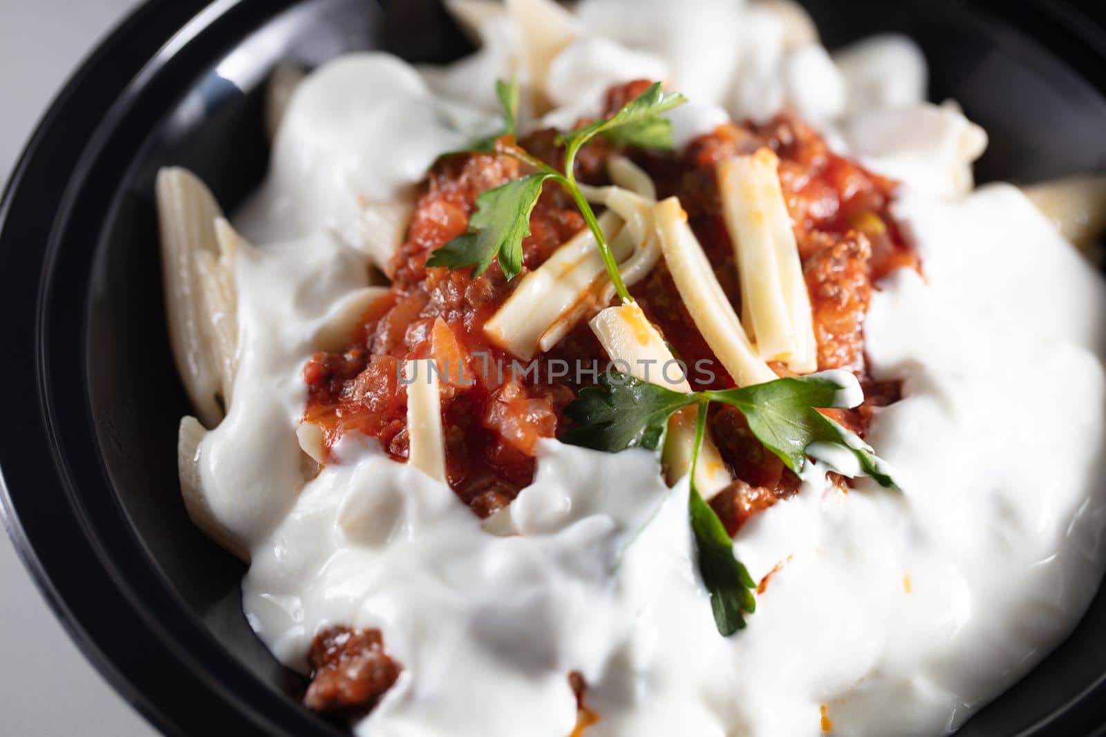 Delicious pasta with sour cream on white table. High quality photo