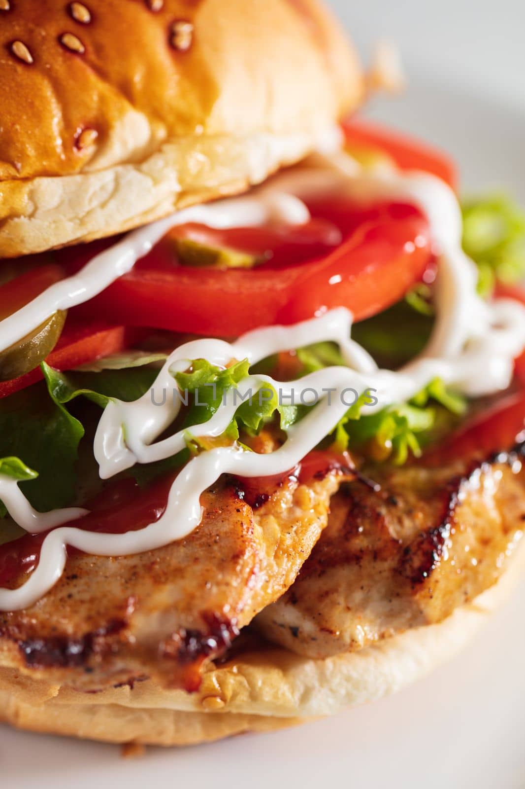 Sandwich with chicken burger, tomatoes, cheese and lettuce. High quality photo