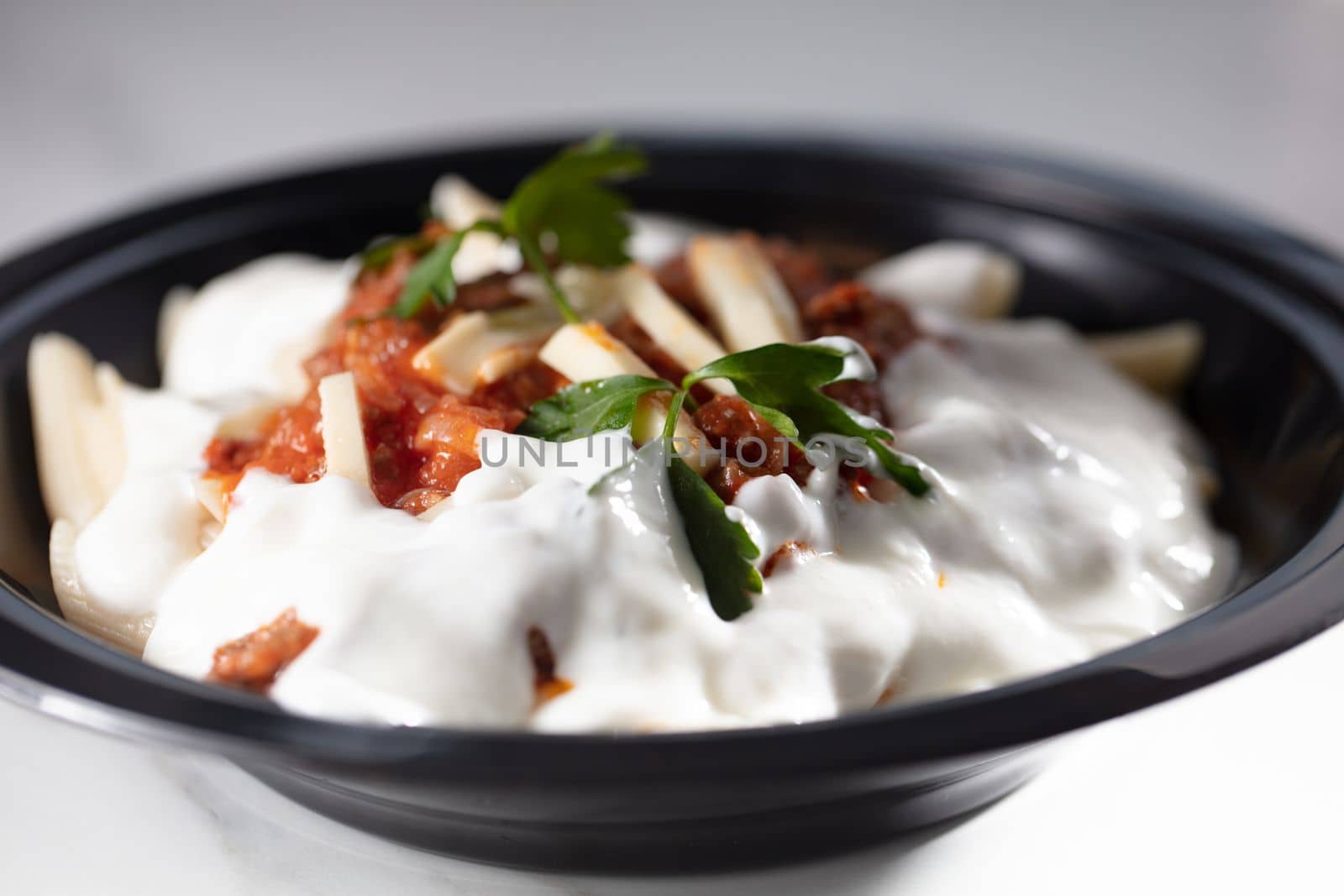 Delicious pasta with sour cream on white table by senkaya