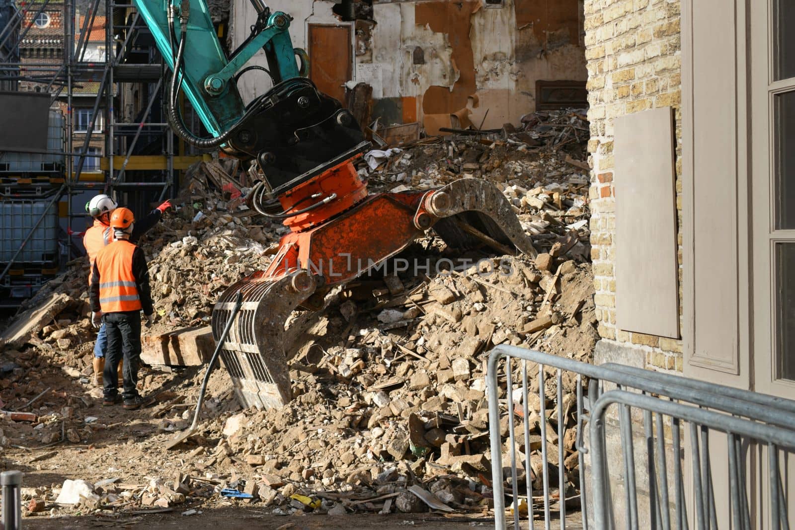 Ruined house. An excavator destroys a house with a bucket.