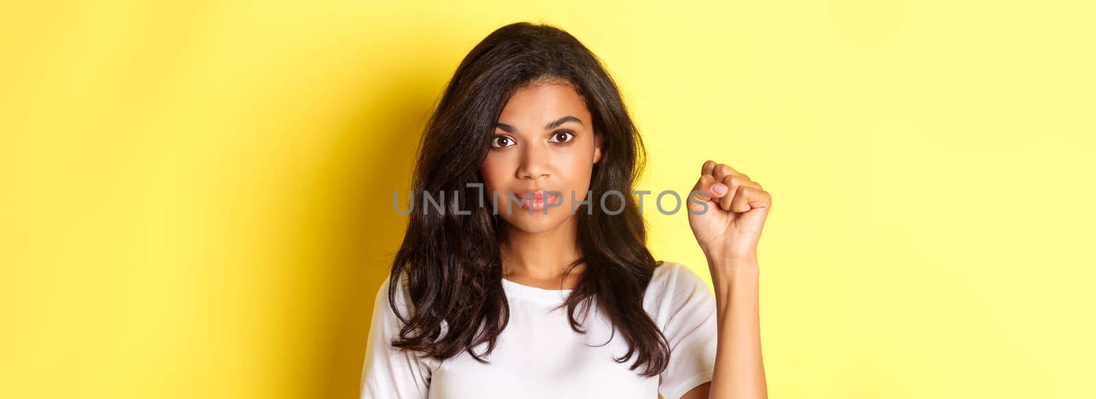 Concept of covid-19, social distancing and lifestyle. Close-up of supportive and confident african-american woman, being a protester in black lives matter movement, staying united by Benzoix