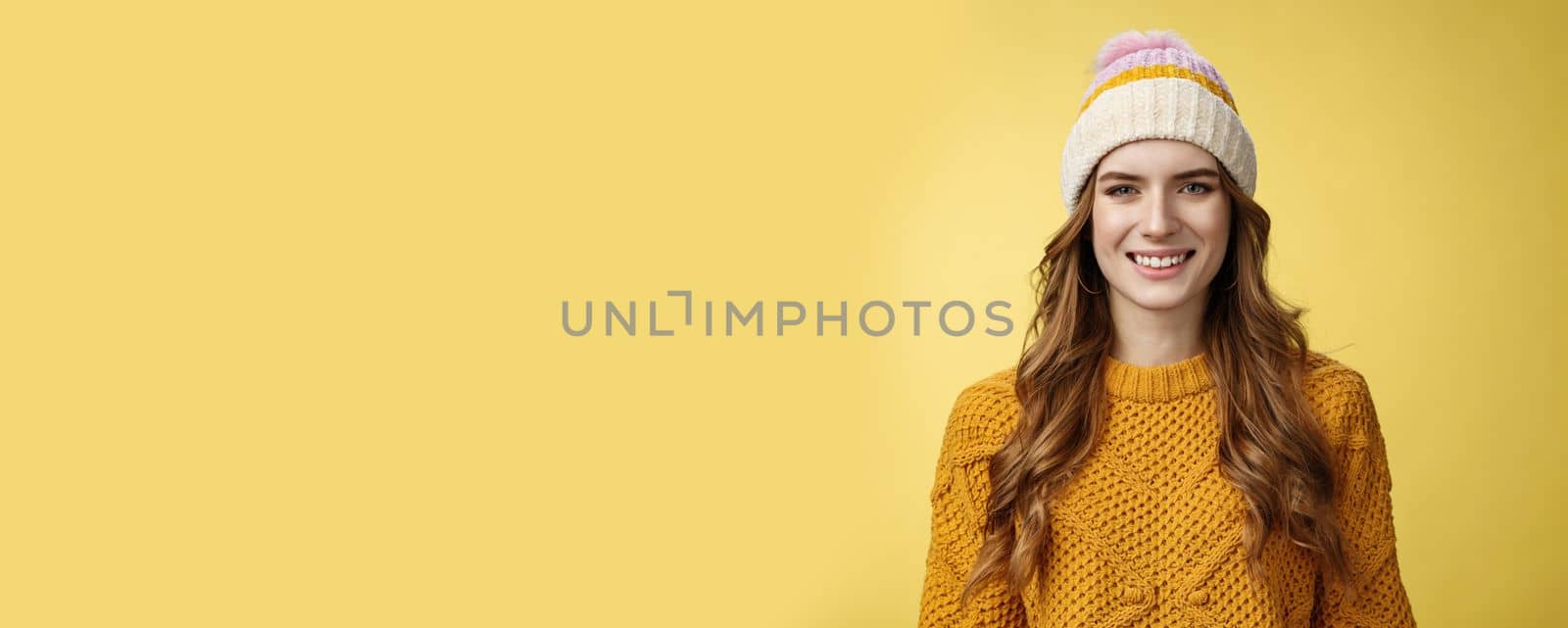 Attractive young friendly-looking outgoing girl dressed warm travel mountains skiing having fun spend winter holidays alps family, smiling broadly wearing corduroy hat sweater, yellow background by Benzoix