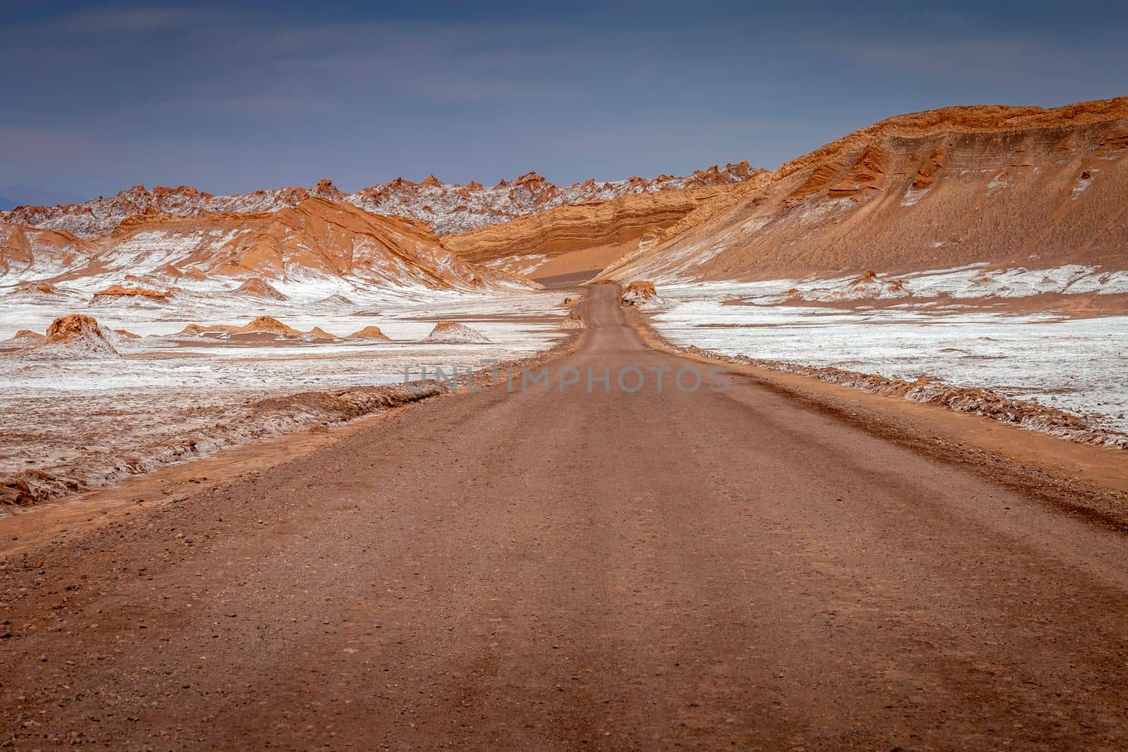 Dirt Road in Peaceful Moon Valley dramatic landscape at Sunset, Atacama Desert, Chile