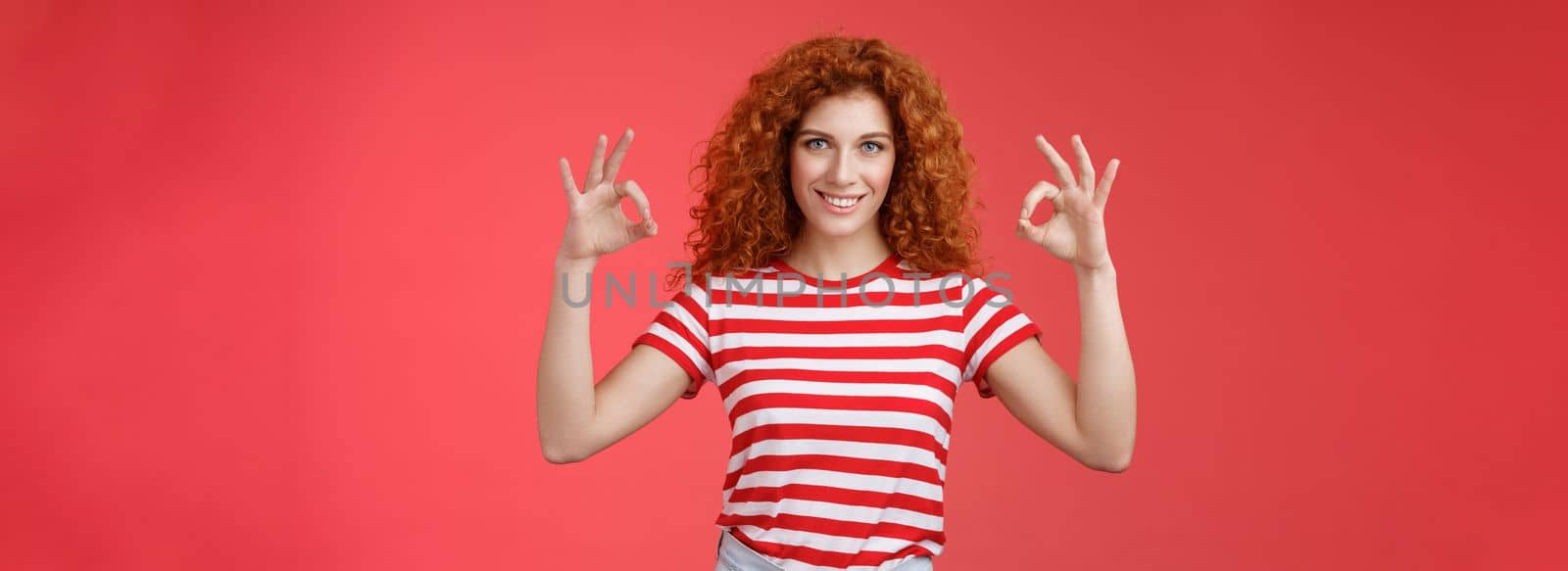 Motivated ambisious good-looking empowered young redhead curly girl assuring everything excellent show okay ok perfection gesture smiling assertive confidently approve like awesome choice.