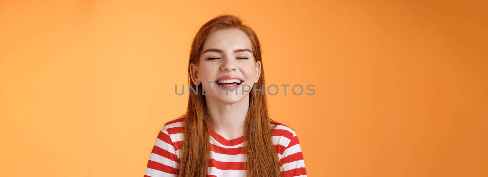 Sincere happy charismatic redhead girl smiling, close eyes enjoy warm summer sunbeams, laughing cheerful, feel relaxed rejoicing, show white teeth, good vacation concept, orange background by Benzoix
