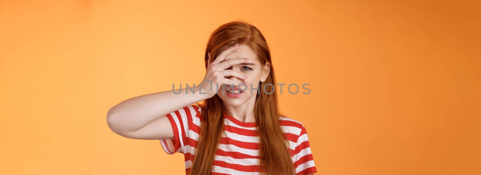 Uneasy redhead girl pity for bad situation, trying not look awful friend wound, cringe aversion, dislike watch horror stories, feel disgust upset, standing uncomfortable clench teeth dislike.