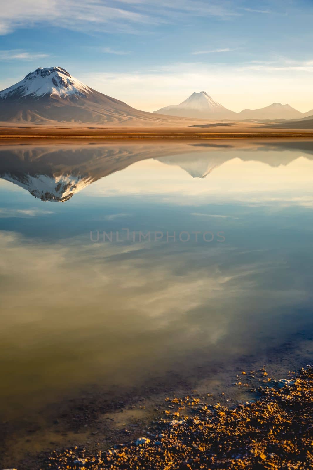 Salt lake Lejia reflection and idyllic volcanic landscape at Sunset, Atacama desert, Chile