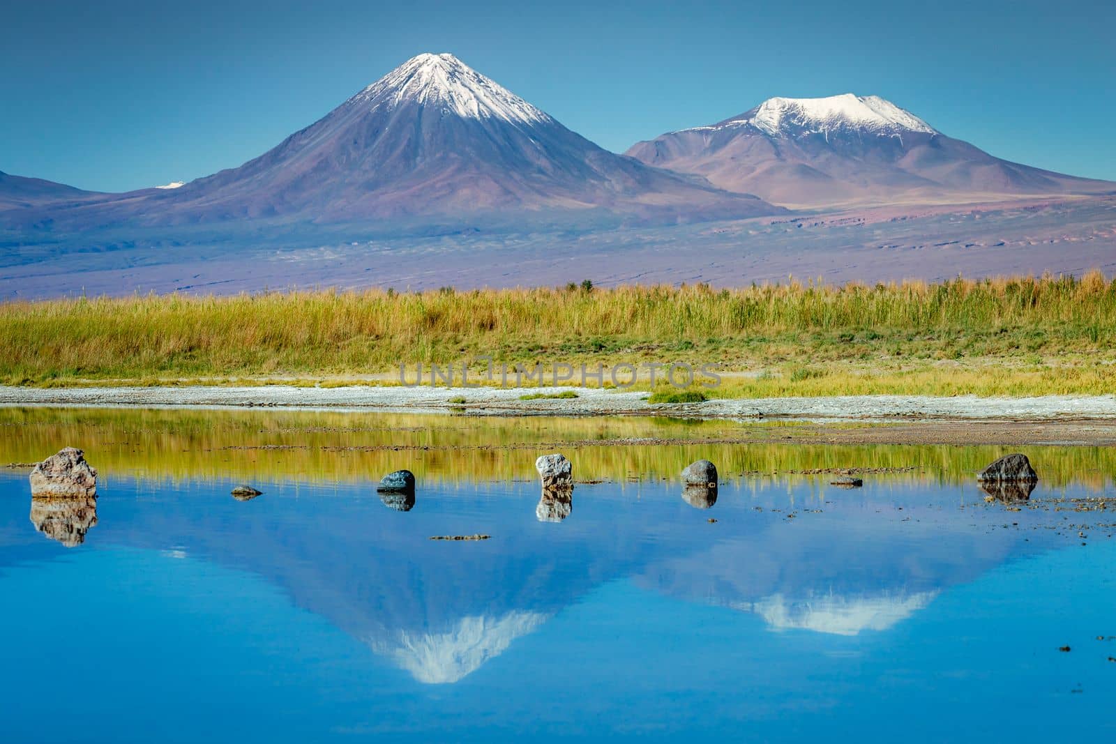 Licancabur and Peaceful reflection lake with dramatic volcanic landscape at Sunset, Atacama Desert, Chile