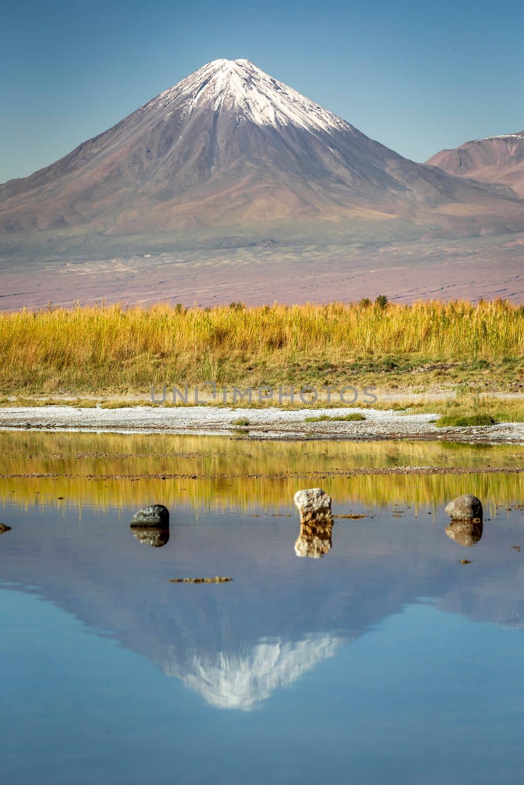 Licancabur and Peaceful reflection lake with dramatic volcanic landscape at Sunset, Atacama Desert, Chile