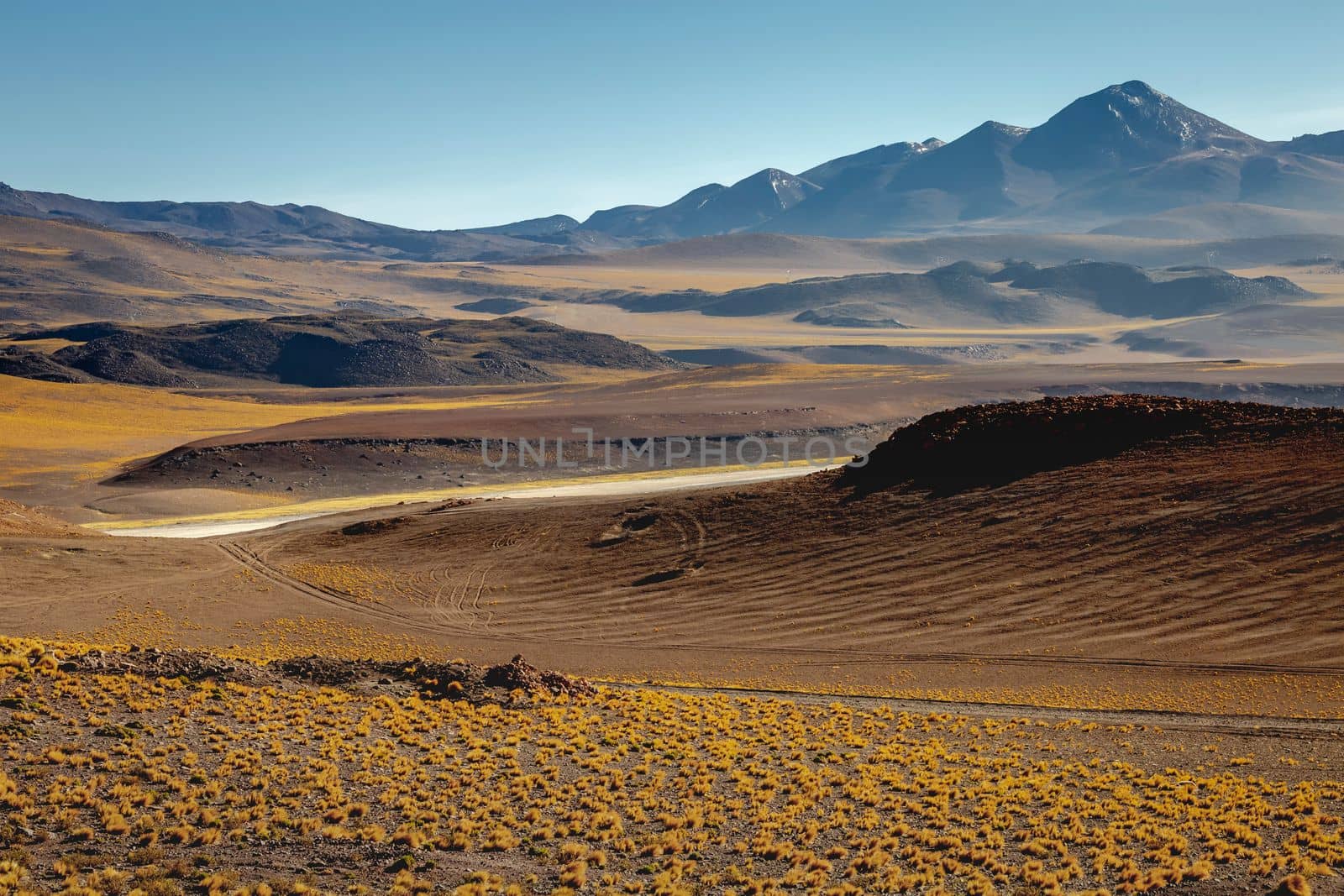 Dirt Road in Peaceful Moon Valley dramatic landscape at Sunset, Atacama Desert, Chile