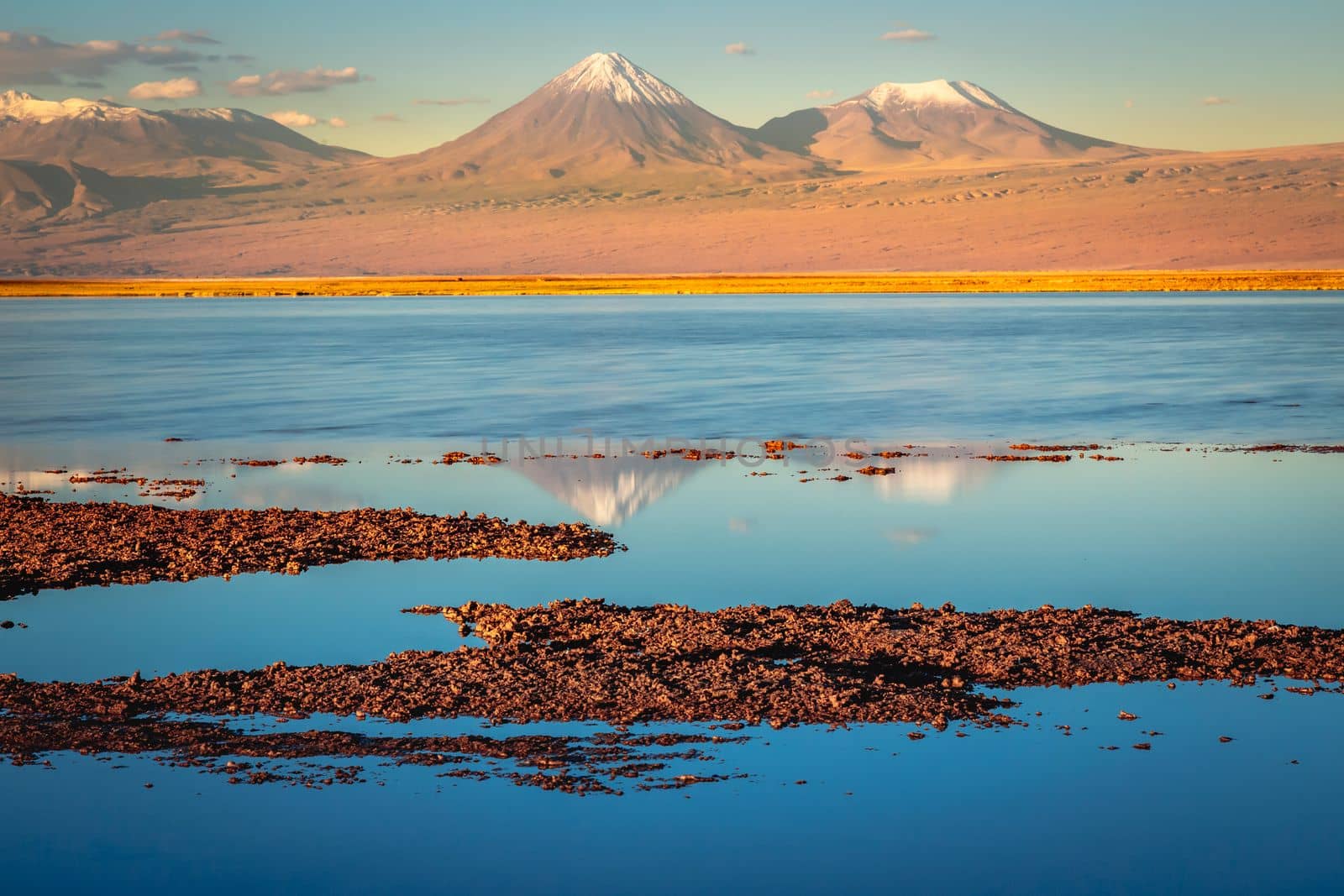 Licancabur and Peaceful reflection lake with dramatic volcanic landscape at Sunset, Atacama Desert, Chile