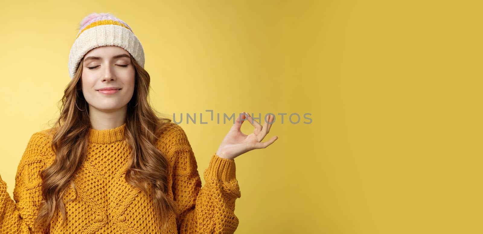 Keep calm carry on. Portrait relieved happy meditating charming young woman learn control feelings breething yoga practice smiling delighted relaxed close eyes hands sideways zen nirvana gesture.