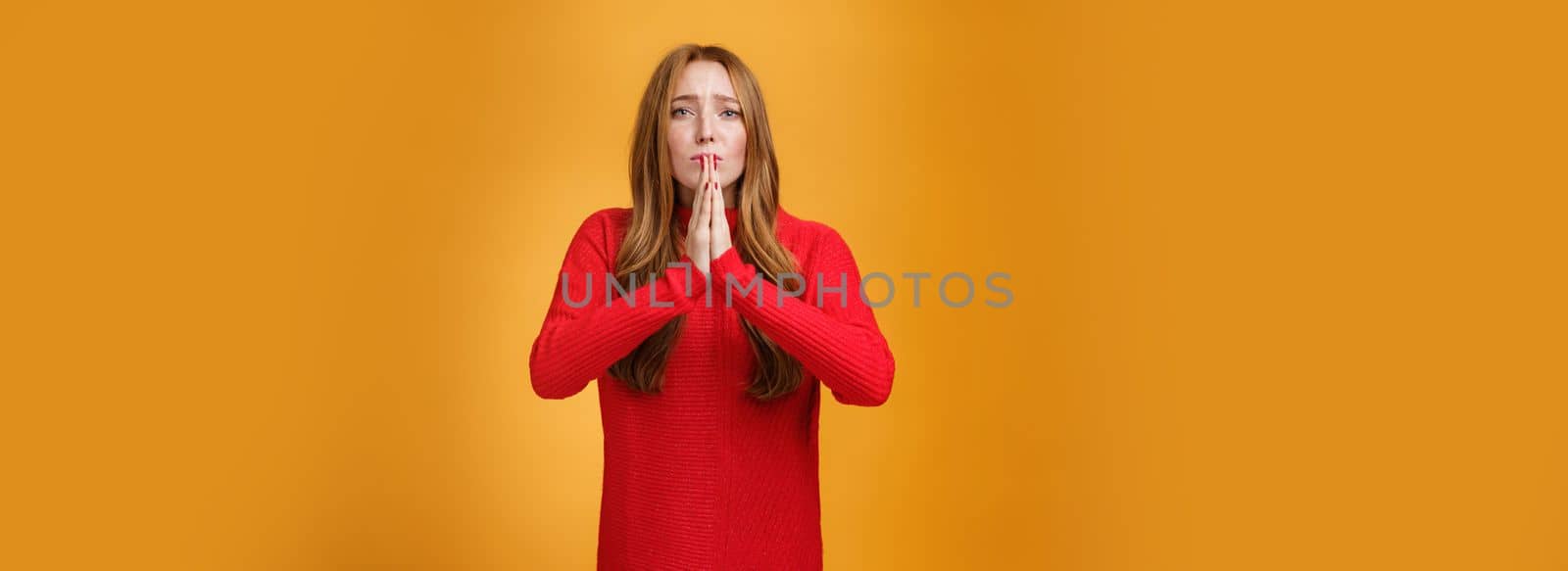 Supplication, apology and people feelings concept. Portrait of sad worried and guilty cute redhead girl begging forgiveness, holding hands in pray asking mercy or sorry frowning in sorrow by Benzoix