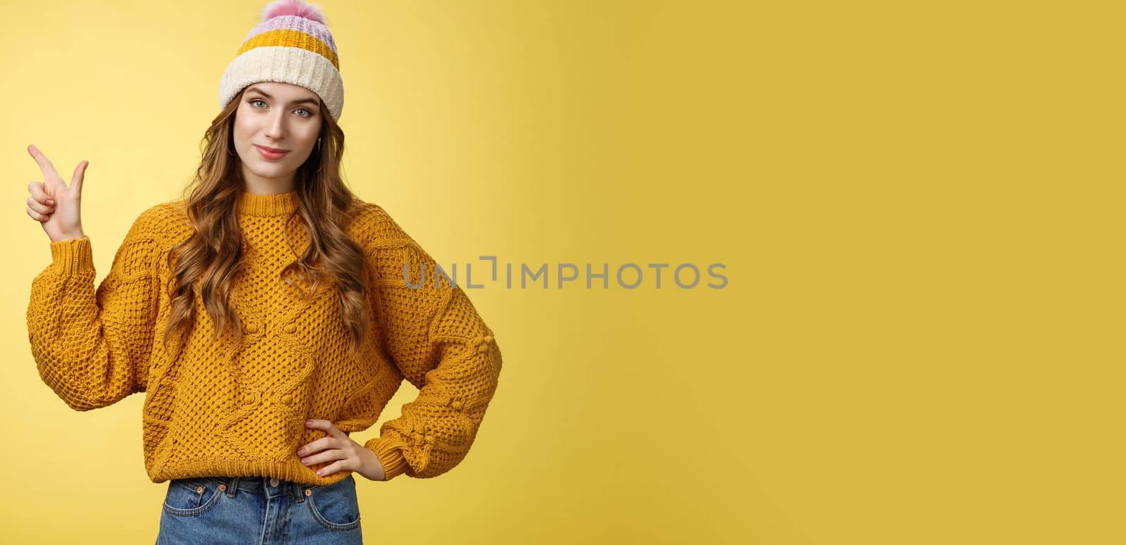 Confident good-looking young female friend telling you buy product immidietely pointing upper left corner smiling hold hand waist self-assured, employee help client pick best merch, yellow background by Benzoix