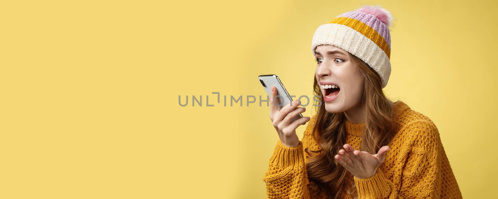 Annoyed pissed freak-out crazy woman shouting smartphone look display near face irritated arguing boyfriend breaking-up via phone call standing angry furiously yelling cellphone, raise hand dismay by Benzoix