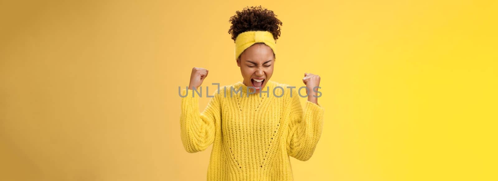 Excited thrilled beautiful young girl student yelling happily clench fists victory triumph pose dancing celebrating acception popular university standing satisfied achieve goal dream come true.