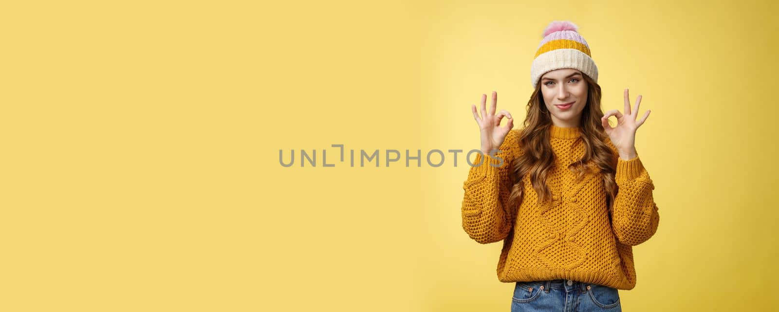 You look awesome. Portrait satisfied good-looking girl show okay gesture delighted good result, excellent perfect work, assuring no problem, smiling devious check out cool shot, yellow background.