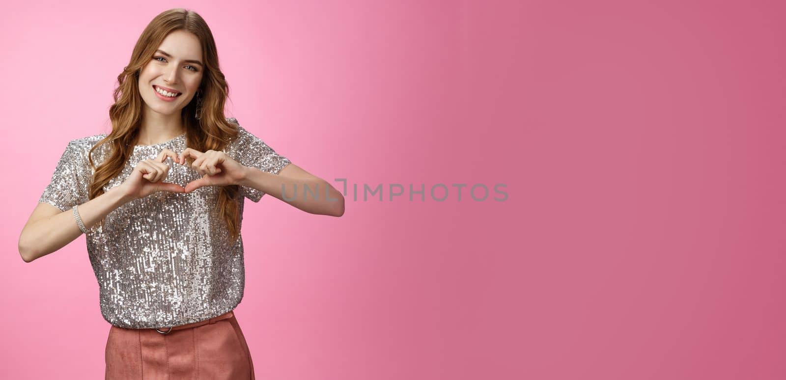 Charming lovely glamour european girlfriend expressing love sympathy afferction smiling cute show heart gesture in love boyfriend adore family relatioship, friendship concept, pink background by Benzoix