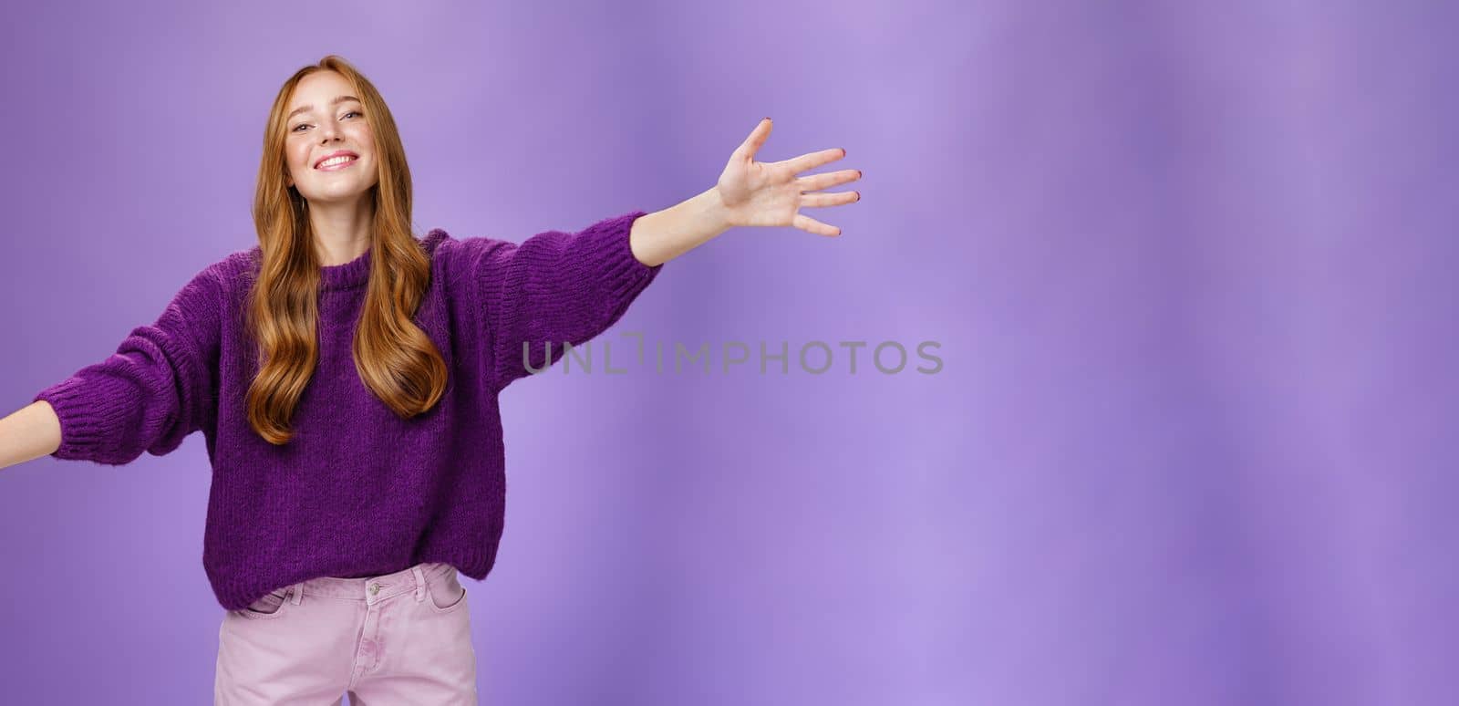 Come into my arms, girl wants give warm hug. Portrait of friendly and cute charming redhead woman stretching hands across copy space and looking forward with happy smile to cuddle and welcome guests.