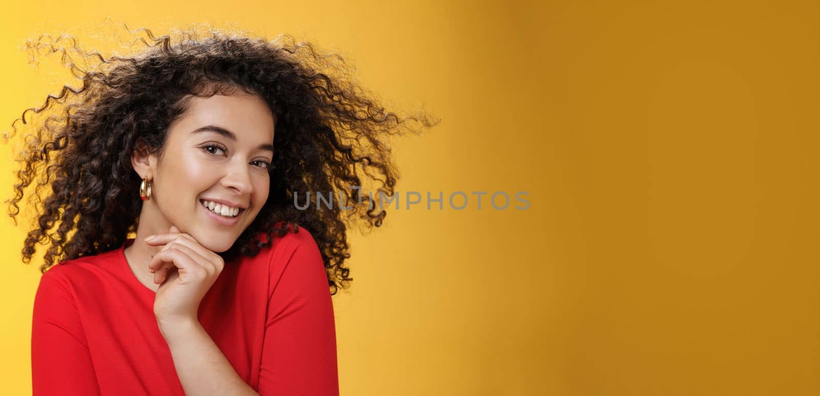 Romance, women and beauty concept. Portrait of tender and gentle pretty woman with curly hair flying in air as she turning head and smiling sensually, flirting with camera touching chin by Benzoix