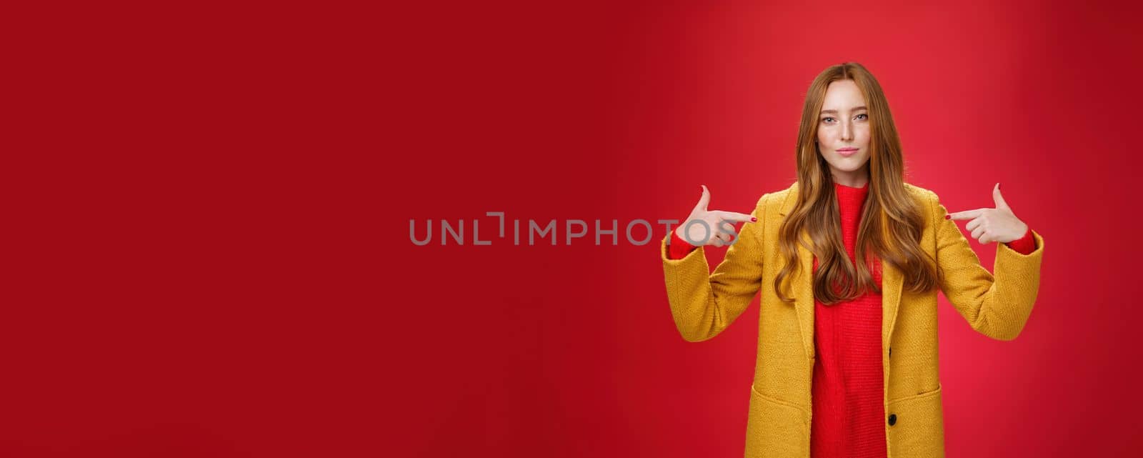 Lifestyle. Self-assured assertive and optimsitic charming female entrepreneur with ginger hair in yellow coat pointing at herself proudly brag own success or willing to be candidate smiling confident.