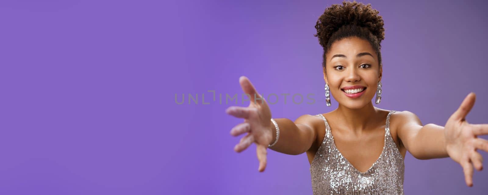 Close-up charming touched tender wealthy african-american woman in silver fashionable dress extend arms towards camera give warm welcome hug smiling delighted wanna cuddle hold in hands by Benzoix