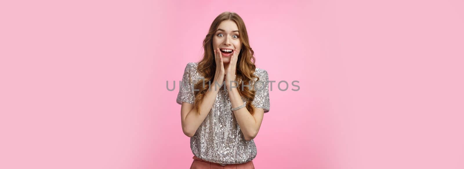 Impressed attractive caucasian charming girlfriend sighing thrill joy drop jaw amazement widen eyes see celebrity press palms cheeks expressing excitement surprise, standing pink background.