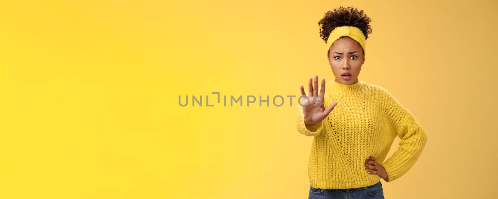 Afraid shocked insecure woman trying show voice be brave extend arm enough stop refusal gesture look frightened insecure unconfident rejecting declining offensive proposal, yellow background by Benzoix