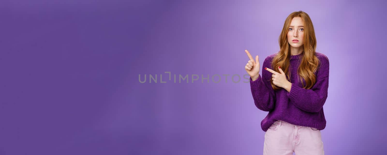 Upset and gloomy woman in sorrow feeling regret of missing huge sales looking reckelss and unhappy pointing questioned at upper left corner with hopeless expression over purple background by Benzoix