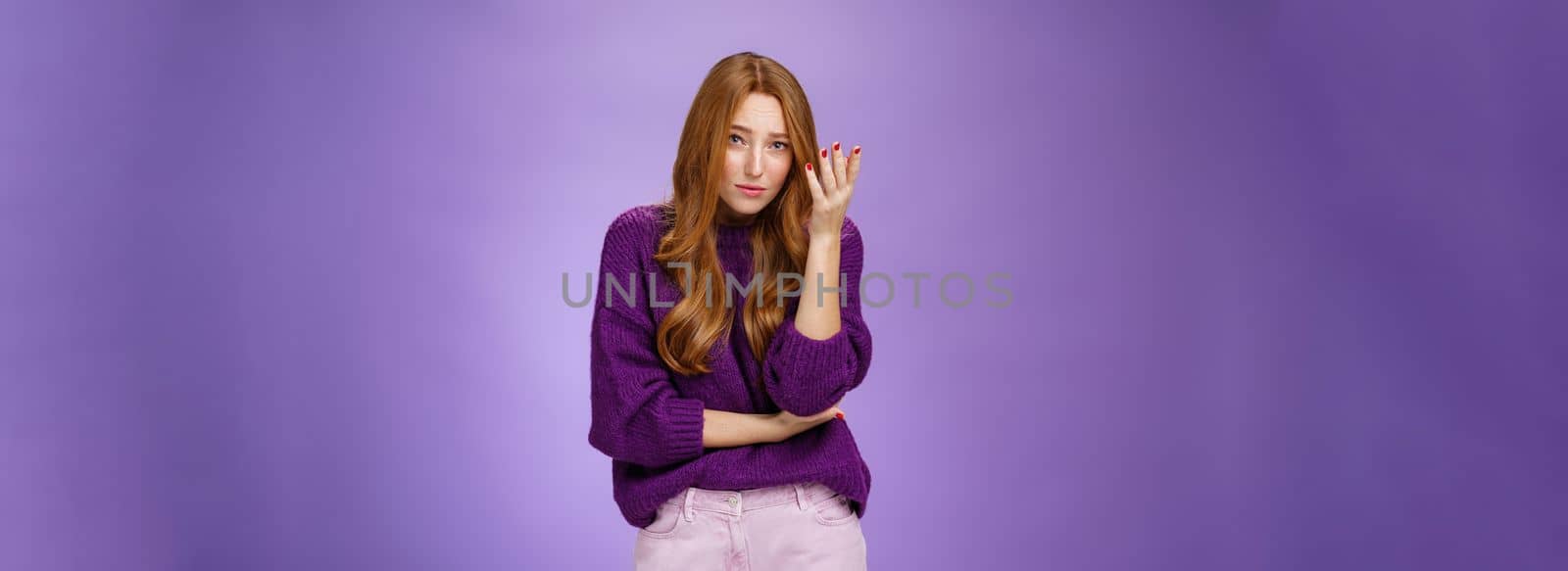 Jeez what you saying. Portrait of redhead 20s female student making facepalm gesture raising eyebrows and looking questioned at camera as being annoyed with dumb and nonsense conversation by Benzoix