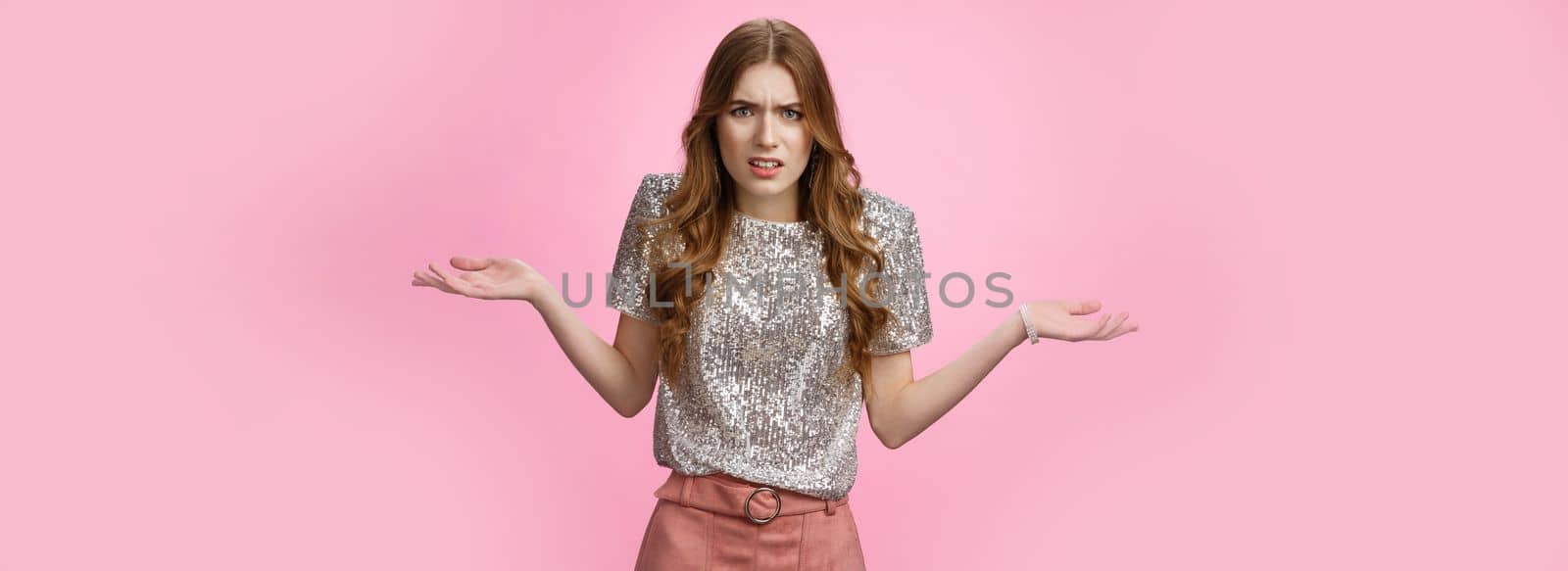 Pissed off annoyed glamour arrogant european woman arguing shrugging cringing displeased bothered spread hands sideways dismay, fighting confused questioned irritated, standing pink background.