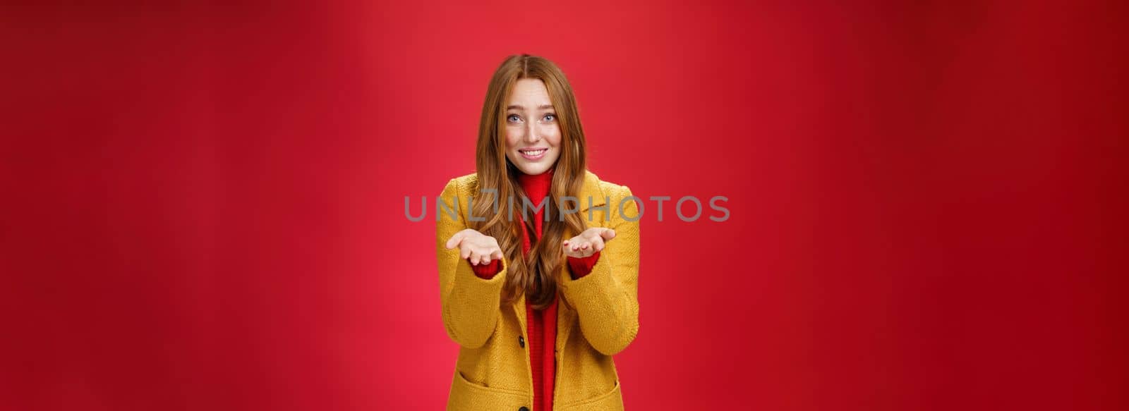 Girl with tender and caring expression smiling extanding hands forward as giving thanks or pointing at someone special feeling admiration thanking partner for support, confessing in love and sympathy by Benzoix
