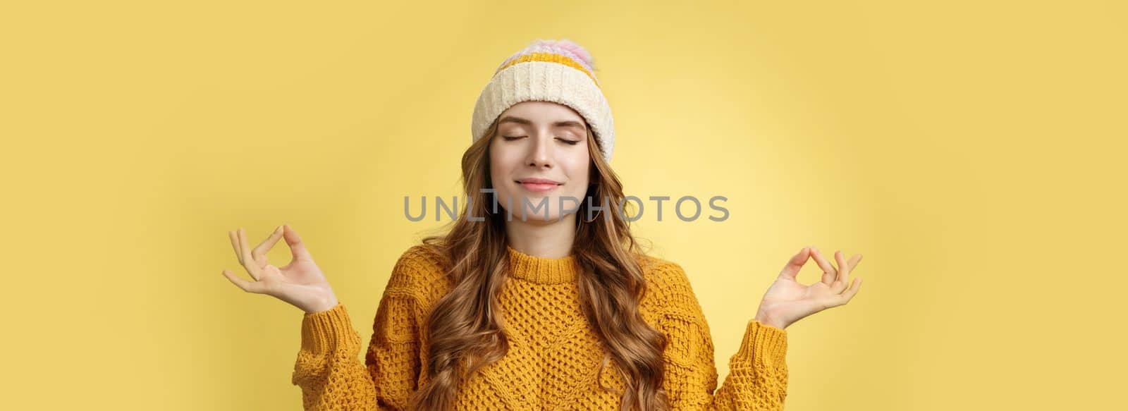 Keep calm carry on. Portrait relieved happy meditating charming young woman learn control feelings breething yoga practice smiling delighted relaxed close eyes hands sideways zen nirvana gesture.