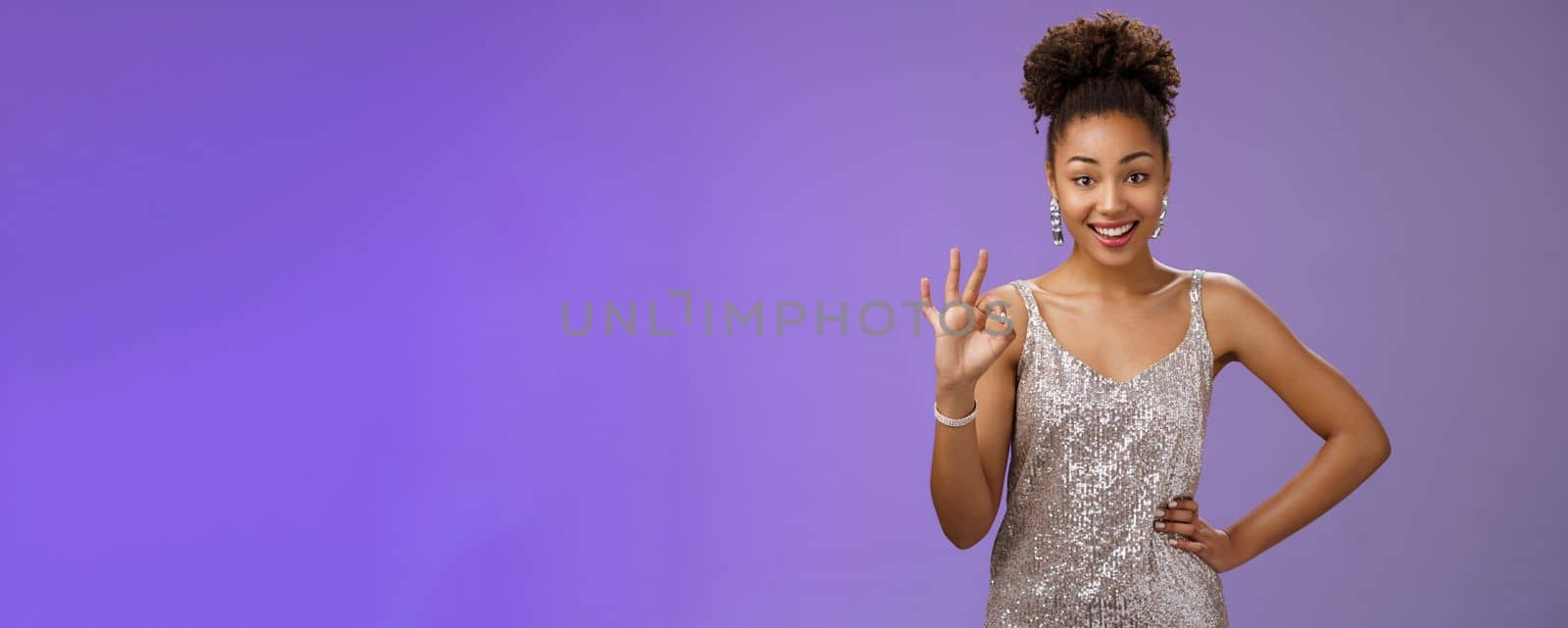 Friendly glad charming elegant african-american woman agree terms show okay ok satisfaction gesture delighted approve good idea standing blue background like plan smiling broadly. Copy space