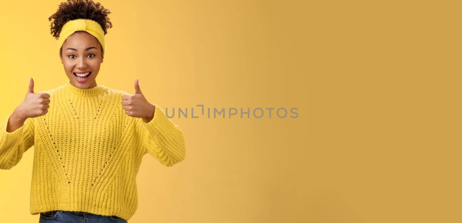 Supportive friendly modern trendy african-american female friend supporting you show thumbs-up keep up good work gesture proud doing best effort, liking result approving plan, yellow background by Benzoix