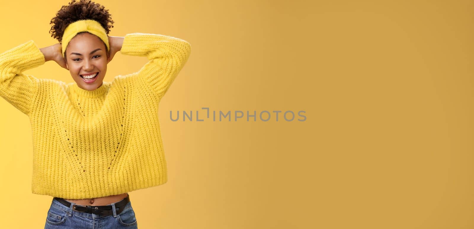 Attractive lucky optimistic african-american woman having fun lay back hands behind head smiling laughing happily enjoying perfect day-off work relaxing spend leisure fun, yellow background by Benzoix